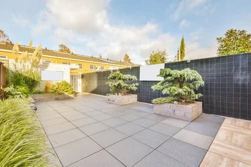 Wide finished concrete patio with clean joint lines beside a modern New Jersey home