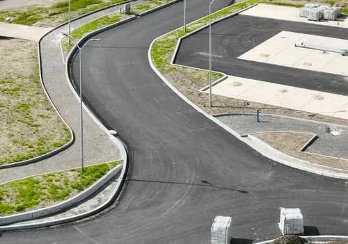 Finished poured concrete roadway and curb work completed by Elements Concrete Construction